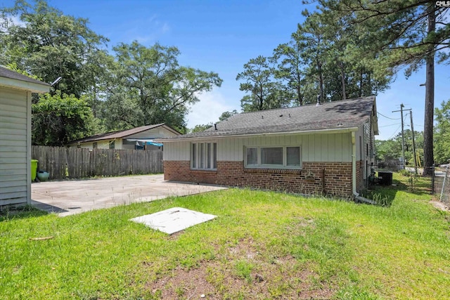 231 Horseshoe Cir, Columbia, SC 29223 - rear view of property with a patio, brick siding, a fenced backyard, and roof with shingles