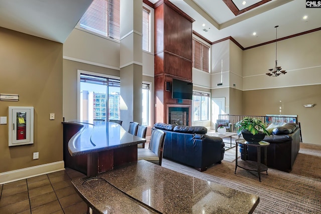 601 Main St Unit 518, Columbia, SC 29201 - living room featuring a high ceiling, a chandelier, dark tile patterned flooring, and recessed lighting