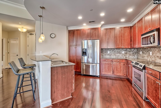 601 Main St Unit 518, Columbia, SC 29201 - kitchen with stainless steel appliances, dark stone countertops, a breakfast bar area, dark wood-style flooring, and recessed lighting
