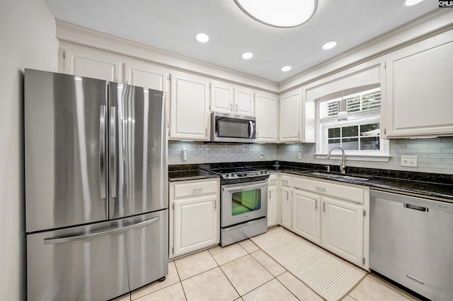 614 Beech Branch Dr, Irmo, SC 29063 - kitchen featuring appliances with stainless steel finishes, white cabinets, decorative backsplash, light tile patterned floors, and recessed lighting