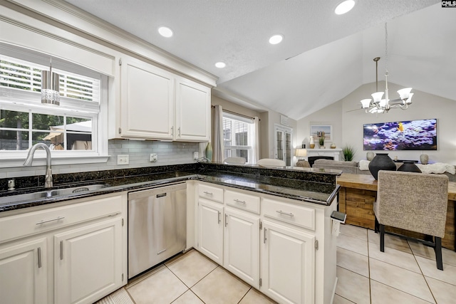 614 Beech Branch Dr, Irmo, SC 29063 - kitchen featuring stainless steel dishwasher, a chandelier, lofted ceiling, light tile patterned floors, and white cabinetry