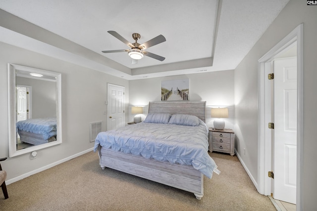 614 Beech Branch Dr, Irmo, SC 29063 - bedroom with light carpet, a tray ceiling, and ceiling fan