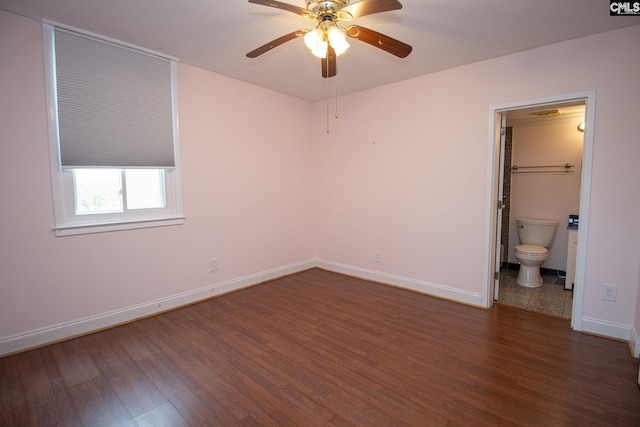 619 King St Unit 801, Columbia, SC 29205 - unfurnished bedroom featuring dark wood finished floors, ensuite bathroom, and a ceiling fan