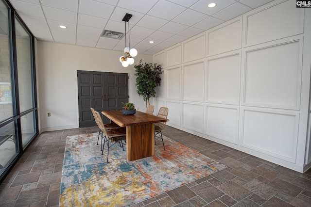 619 King St Unit 801, Columbia, SC 29205 - dining area featuring stone tile flooring, recessed lighting, and a paneled ceiling