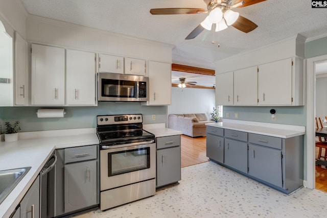 9628 Highgate Rd, Columbia, SC 29223 - kitchen with stainless steel appliances, ceiling fan, a textured ceiling, light countertops, and white cabinetry