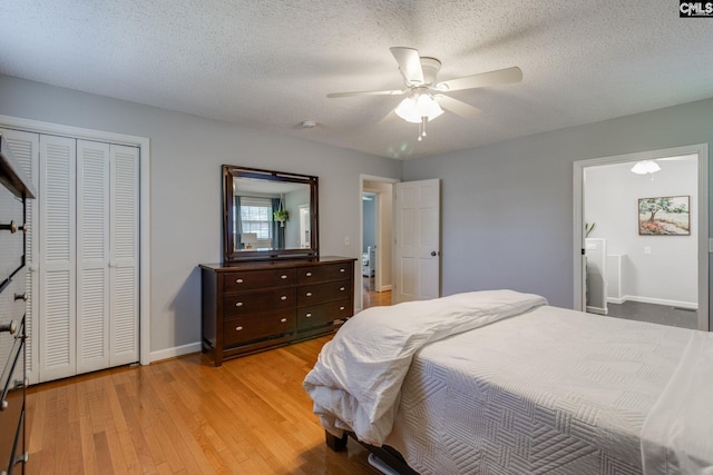9628 Highgate Rd, Columbia, SC 29223 - bedroom featuring light wood finished floors, a closet, a ceiling fan, and a textured ceiling