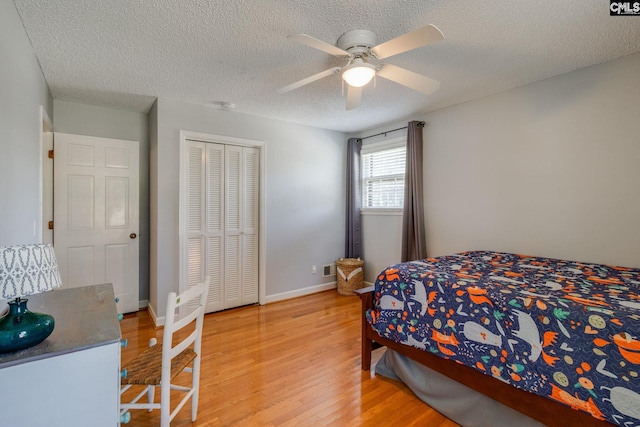 9628 Highgate Rd, Columbia, SC 29223 - bedroom with light wood-style floors, a textured ceiling, a ceiling fan, and a closet