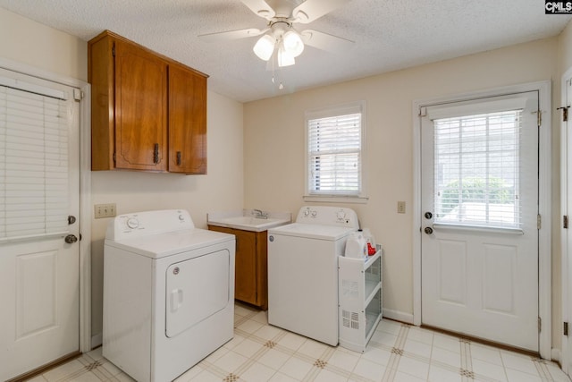 9628 Highgate Rd, Columbia, SC 29223 - laundry area with washing machine and clothes dryer, cabinet space, plenty of natural light, a ceiling fan, and a textured ceiling