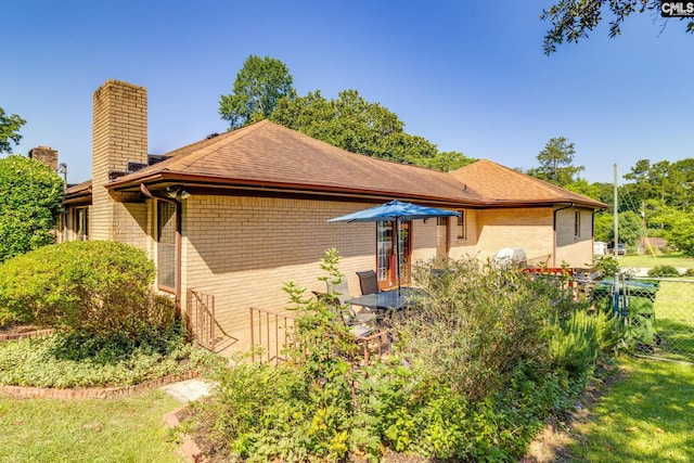 9628 Highgate Rd, Columbia, SC 29223 - view of side of home with brick siding, a chimney, and a shingled roof