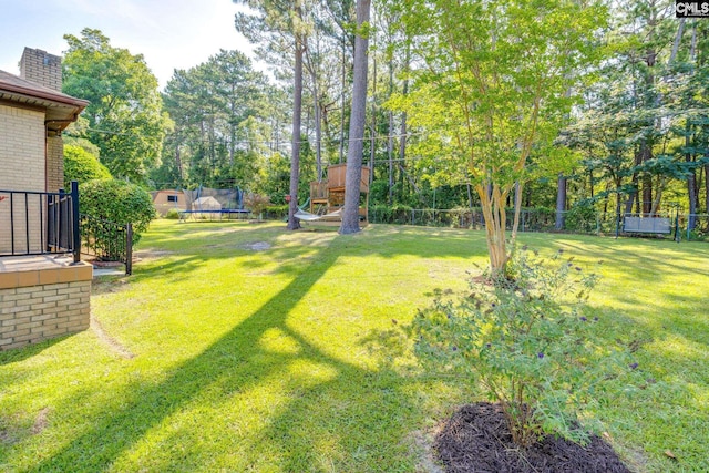 9628 Highgate Rd, Columbia, SC 29223 - view of green lawn featuring a trampoline and view of scattered trees