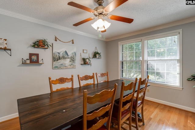 9628 Highgate Rd, Columbia, SC 29223 - dining room featuring light wood-style floors, a textured ceiling, ornamental molding, and a ceiling fan