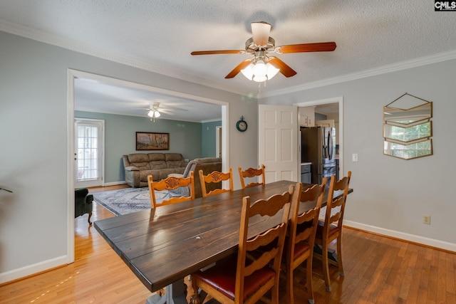 9628 Highgate Rd, Columbia, SC 29223 - dining space with light wood-type flooring, a ceiling fan, crown molding, and a textured ceiling