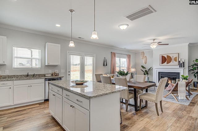 2095 County Line Trl, Elgin, SC 29045 - kitchen featuring dishwasher, a ceiling fan, crown molding, a center island, and light wood-style flooring