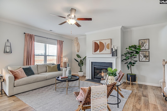 2095 County Line Trl, Elgin, SC 29045 - living room featuring crown molding, wood finished floors, a fireplace with flush hearth, and ceiling fan
