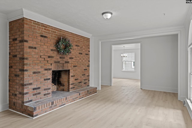 4405 Palmetto Ave, Columbia, SC 29203 - unfurnished living room featuring light wood finished floors, crown molding, a chandelier, and a brick fireplace
