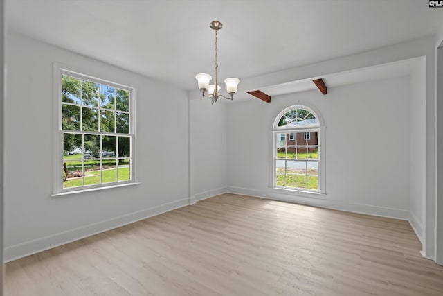 4405 Palmetto Ave, Columbia, SC 29203 - empty room with a chandelier, light wood-style flooring, and beamed ceiling