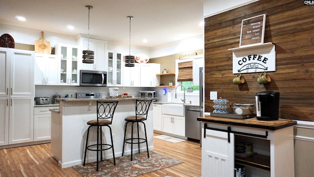 2367 Mount Pilgrim Church Rd, Prosperity, SC 29127 - kitchen featuring appliances with stainless steel finishes, open shelves, a kitchen island, a kitchen breakfast bar, and decorative backsplash