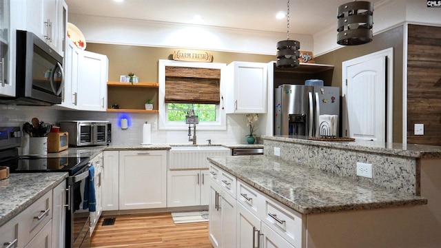 2367 Mount Pilgrim Church Rd, Prosperity, SC 29127 - kitchen with appliances with stainless steel finishes, open shelves, white cabinetry, decorative backsplash, and light wood finished floors