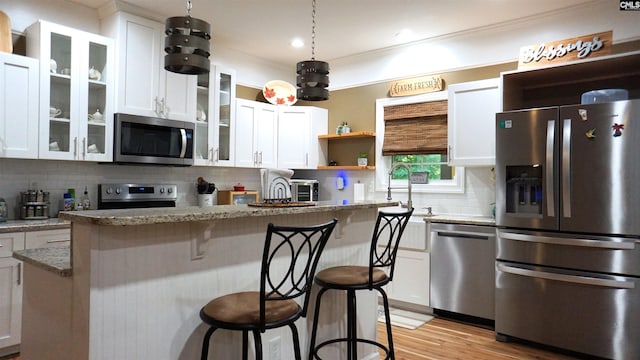 2367 Mount Pilgrim Church Rd, Prosperity, SC 29127 - kitchen with appliances with stainless steel finishes, white cabinets, and a kitchen breakfast bar