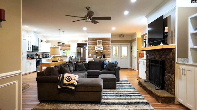 2367 Mount Pilgrim Church Rd, Prosperity, SC 29127 - living area featuring ceiling fan, wood finished floors, a stone fireplace, recessed lighting, and healthy amount of natural light
