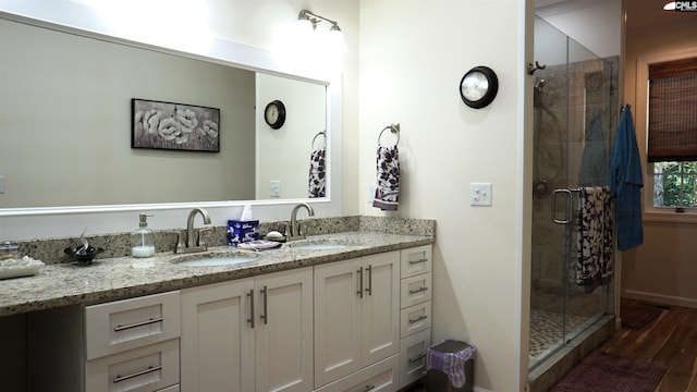 2367 Mount Pilgrim Church Rd, Prosperity, SC 29127 - bathroom with double vanity, a shower stall, and wood finished floors