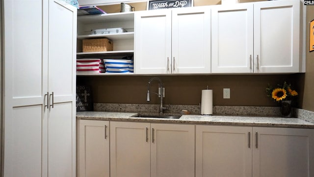 2367 Mount Pilgrim Church Rd, Prosperity, SC 29127 - kitchen featuring open shelves, white cabinets, and light stone counters