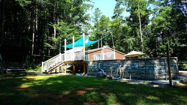 2367 Mount Pilgrim Church Rd, Prosperity, SC 29127 - rear view of property with stairway, a lawn, a deck, and a trampoline