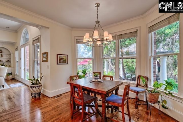 426 Turkey Point Cir, Columbia, SC 29223 - dining room with a chandelier, healthy amount of natural light, wood finished floors, and crown molding