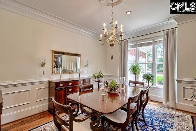 426 Turkey Point Cir, Columbia, SC 29223 - dining area featuring a chandelier, crown molding, wainscoting, a decorative wall, and wood finished floors