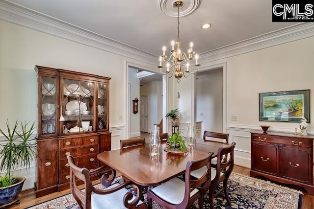 426 Turkey Point Cir, Columbia, SC 29223 - dining area with a chandelier, light wood-style floors, ornamental molding, wainscoting, and a decorative wall