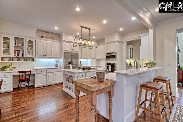 426 Turkey Point Cir, Columbia, SC 29223 - kitchen with stainless steel appliances, crown molding, white cabinets, a breakfast bar, and open shelves