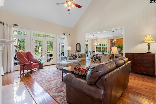 132 Alston Cir, Lexington, SC 29072 - living room with high vaulted ceiling, ceiling fan, light wood-style flooring, and a chandelier
