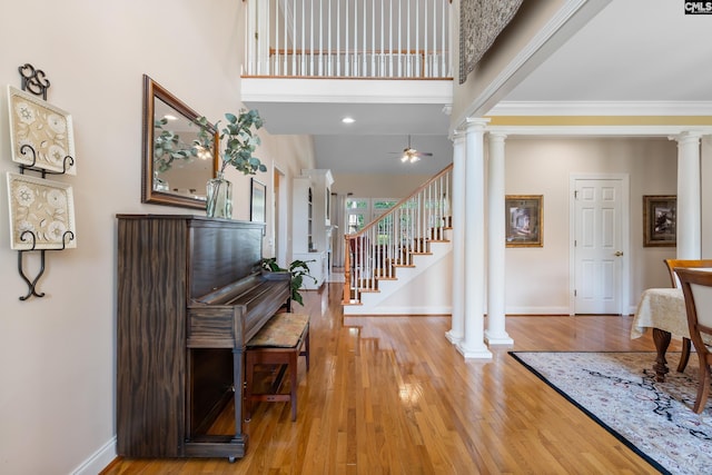 132 Alston Cir, Lexington, SC 29072 - entryway with ornate columns, light wood finished floors, crown molding, stairs, and a ceiling fan