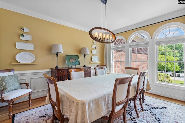 132 Alston Cir, Lexington, SC 29072 - dining area featuring crown molding, a chandelier, light wood-style floors, and wainscoting