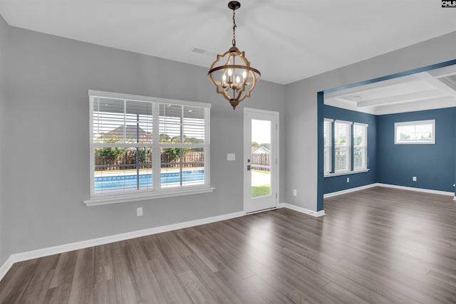 4040 Summerland Way, Elgin, SC 29045 - unfurnished room with a chandelier, dark wood-style flooring, and beamed ceiling