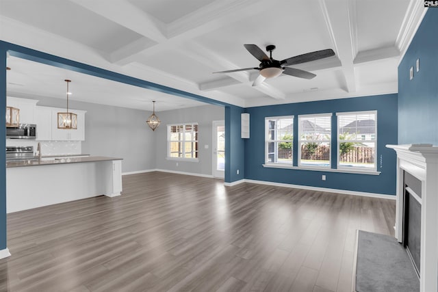 4040 Summerland Way, Elgin, SC 29045 - unfurnished living room featuring a fireplace with flush hearth, coffered ceiling, a chandelier, plenty of natural light, and dark wood-type flooring