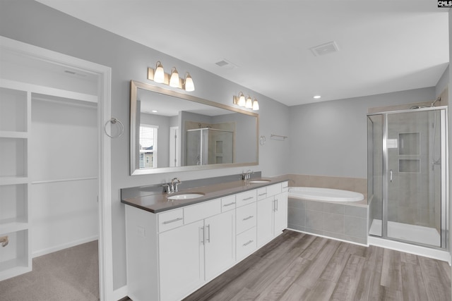 4040 Summerland Way, Elgin, SC 29045 - full bath featuring a garden tub, double vanity, a stall shower, and wood finished floors