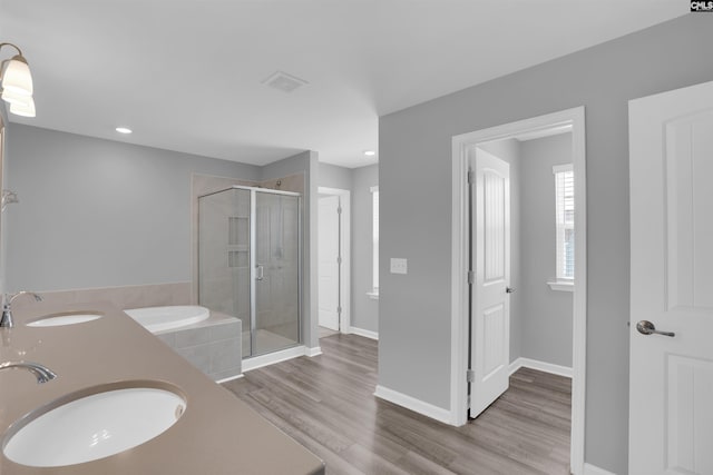 4040 Summerland Way, Elgin, SC 29045 - bathroom featuring a shower stall, wood finished floors, a garden tub, double vanity, and recessed lighting