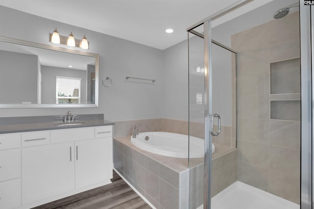 4040 Summerland Way, Elgin, SC 29045 - full bath featuring a stall shower, a bath, vanity, wood finished floors, and recessed lighting