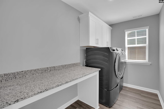 4040 Summerland Way, Elgin, SC 29045 - laundry room with separate washer and dryer, light wood-style floors, and cabinet space