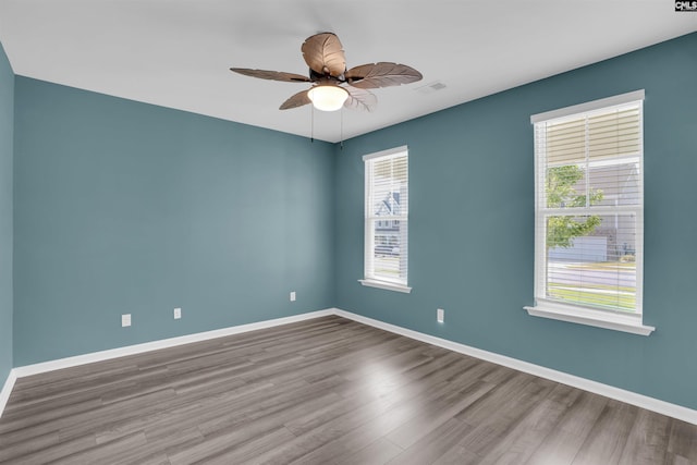 4040 Summerland Way, Elgin, SC 29045 - spare room with healthy amount of natural light, wood finished floors, and a ceiling fan
