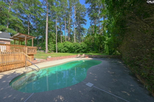 77 Olde Springs Rd, Columbia, SC 29223 - outdoor pool with a patio area, a deck, and view of wooded area