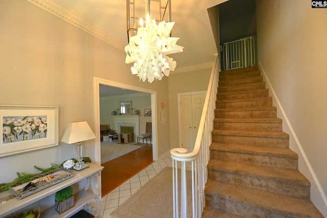 77 Olde Springs Rd, Columbia, SC 29223 - staircase with crown molding, tile patterned floors, a chandelier, and a fireplace