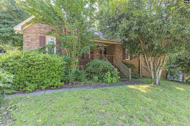 131 Firebranch St, Columbia, SC 29212 - obstructed view of property with brick siding, a front yard, stairs, and covered porch