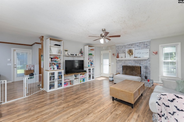 131 Firebranch St, Columbia, SC 29212 - living room featuring a textured ceiling, a ceiling fan, wood finished floors, and a fireplace