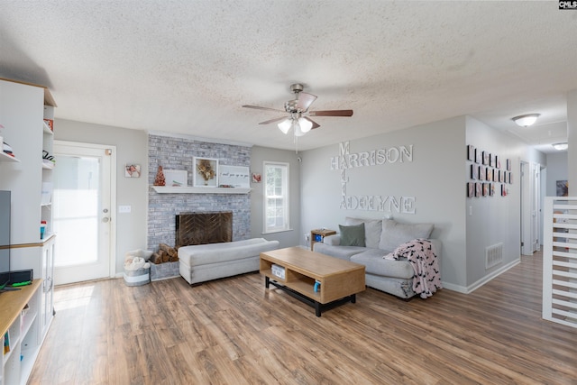 131 Firebranch St, Columbia, SC 29212 - living area with a textured ceiling, ceiling fan, wood finished floors, and a brick fireplace