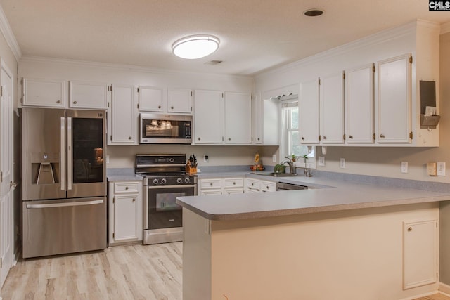 112 Pebble Place Ct, Lexington, SC 29072 - kitchen with appliances with stainless steel finishes, crown molding, a peninsula, light wood finished floors, and white cabinetry
