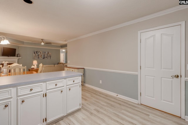 112 Pebble Place Ct, Lexington, SC 29072 - kitchen with crown molding, white cabinetry, light wood-style flooring, light countertops, and a ceiling fan
