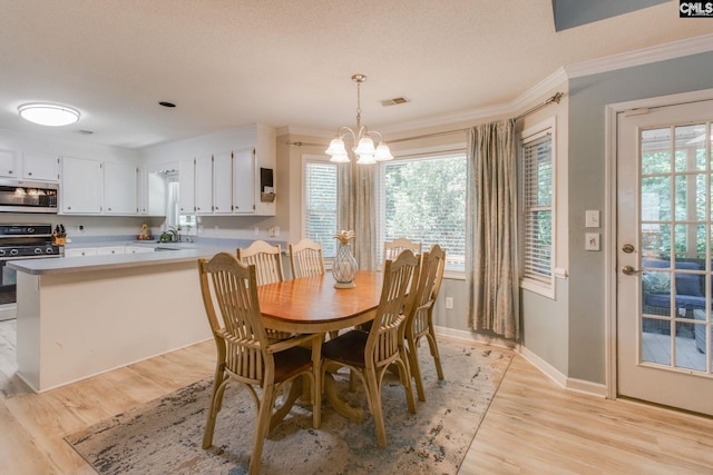 112 Pebble Place Ct, Lexington, SC 29072 - dining room with crown molding, light wood-type flooring, a chandelier, and a textured ceiling