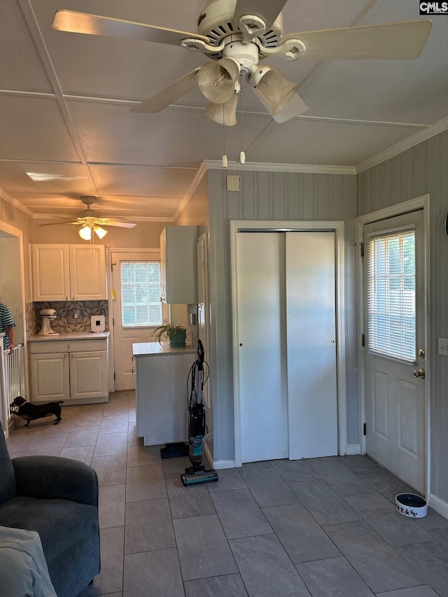 2324 Morningside Dr, West Columbia, SC 29169 - kitchen with ceiling fan, light tile patterned floors, decorative backsplash, ornamental molding, and white cabinets